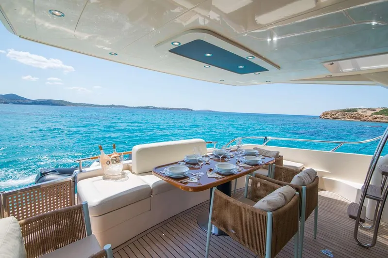  Yacht Photos Pics Luxurious dining area on a 2000 Riva 70 Dolcevita yacht with ocean view.
