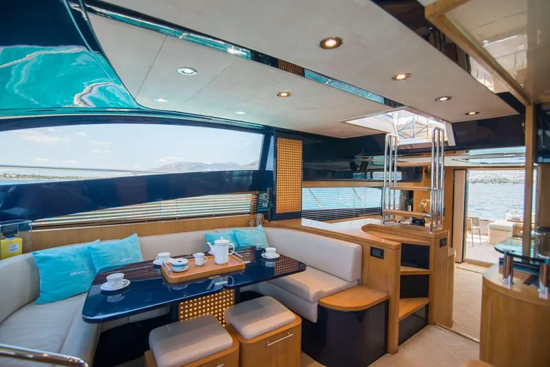  Yacht Photos Pics Luxurious interior of a 2000 Riva 70 Dolcevita yacht with elegant seating and dining area.
