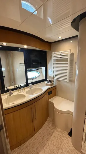  Yacht Photos Pics Luxurious bathroom in 2000 Riva 70 Dolcevita yacht with dual sinks and modern fixtures.