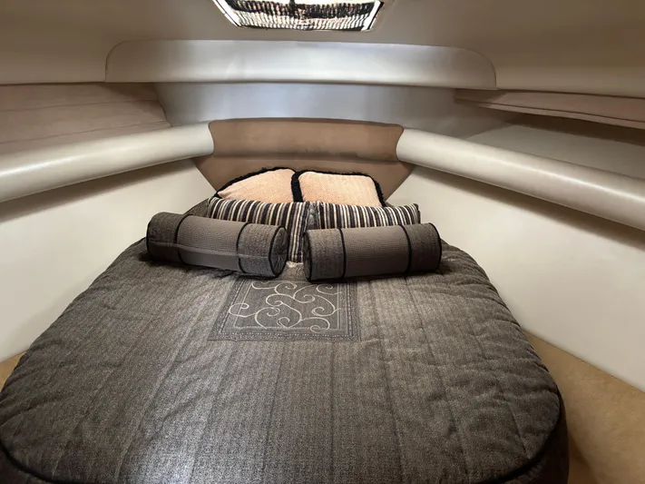  Yacht Photos Pics Luxurious cabin interior of a 2004 Riviera 4000 yacht with elegant bedding and cushions.