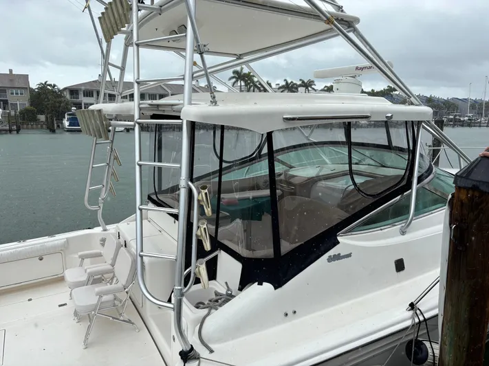  Yacht Photos Pics 2004 Riviera 4000 yacht docked, featuring a sleek design and spacious deck area.