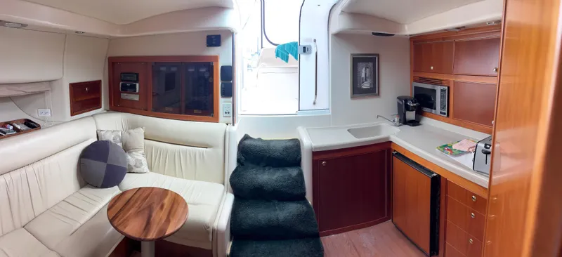  Yacht Photos Pics Luxurious 2004 Riviera 4000 yacht interior with plush seating, kitchenette, and modern amenities.