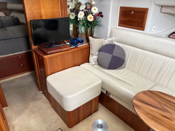  Yacht Photos Pics Luxurious interior of 2004 Riviera 4000 yacht with TV, seating, and floral decor.
