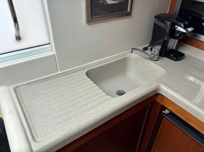  Yacht Photos Pics Kitchen sink area in a 2004 Riviera 4000 boat, featuring a modern faucet and countertop.