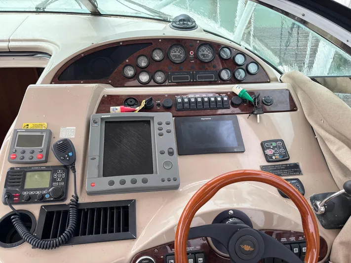  Yacht Photos Pics Control panel of a 2004 Riviera 4000 boat with navigation and communication equipment.