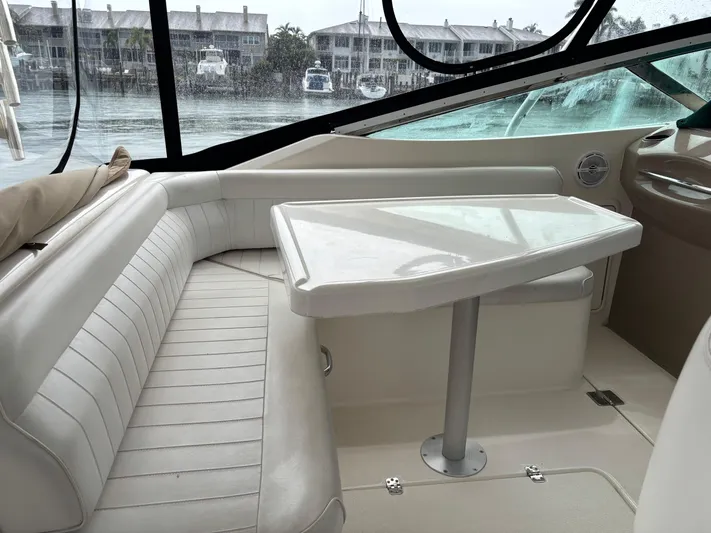  Yacht Photos Pics Interior of a 2004 Riviera 4000 yacht with white seating and table.