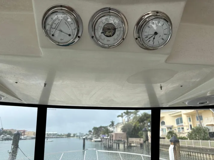 Yacht Photos Pics 2004 Riviera 4000 yacht dashboard with gauges, overlooking a marina view.