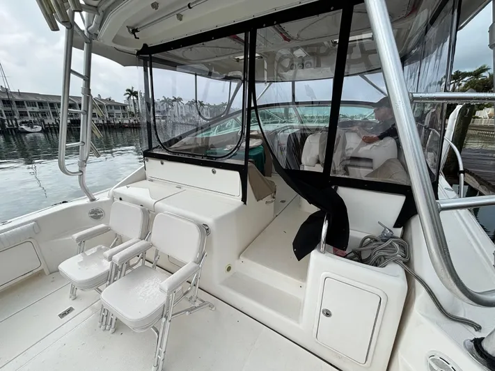  Yacht Photos Pics 2004 Riviera 4000 yacht interior with seating, docked at marina.