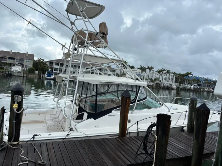  Yacht Photos Pics 2004 Riviera 4000 yacht docked at marina with cloudy sky backdrop.