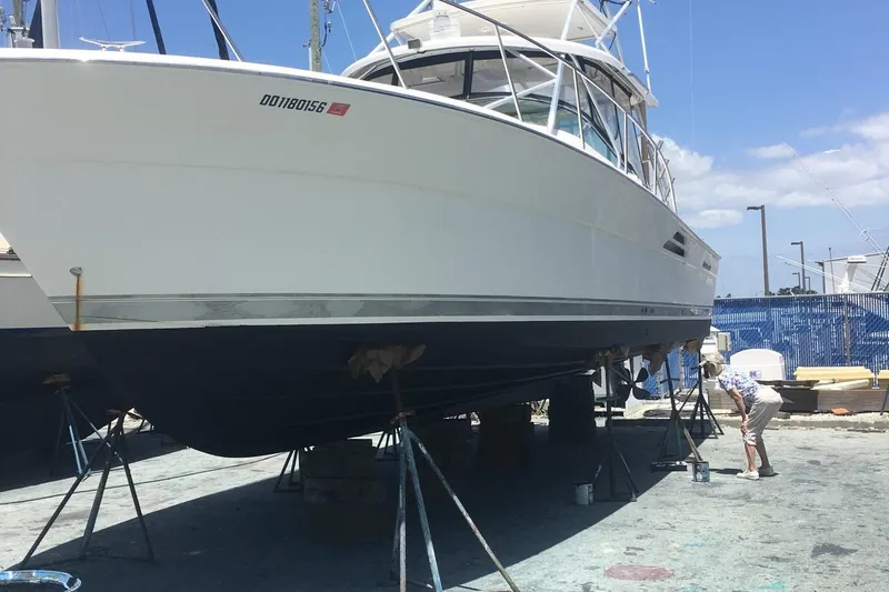  Yacht Photos Pics 2004 Riviera 4000 yacht on dry dock for maintenance under clear blue sky.