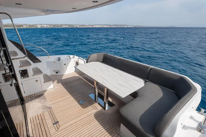 II Zoes Yacht Photos Pics Luxurious 2023 Azimut Fly 53 yacht deck with elegant seating and ocean view.