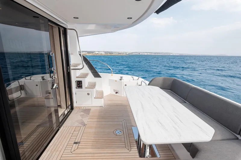 II Zoes Yacht Photos Pics Luxurious 2023 Azimut Fly 53 yacht deck with elegant seating and ocean view.