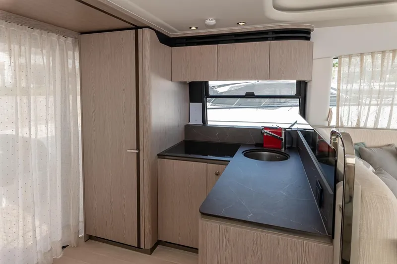 II Zoes Yacht Photos Pics Modern kitchen interior of 2023 Azimut Fly 53 yacht with sleek cabinetry and countertops.