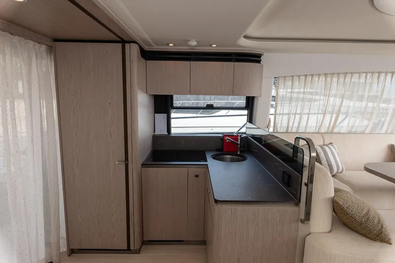 II Zoes Yacht Photos Pics Modern kitchen interior of 2023 Azimut Fly 53 yacht with sleek design and neutral tones.