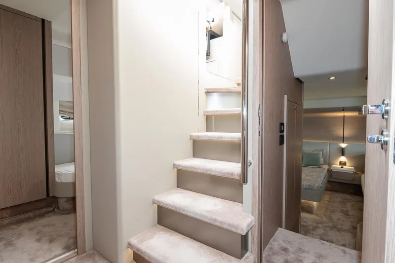 II Zoes Yacht Photos Pics Luxurious interior of 2023 Azimut Fly 53 yacht, featuring elegant staircase and cozy bedroom.