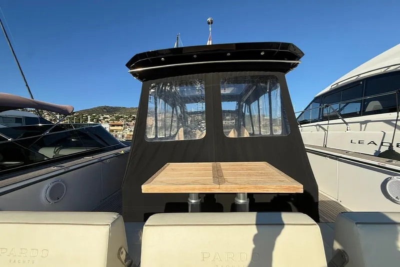 Seoi Yacht Photos Pics 2024 Pardo Yachts P43 with outdoor seating and table, docked under clear blue sky.