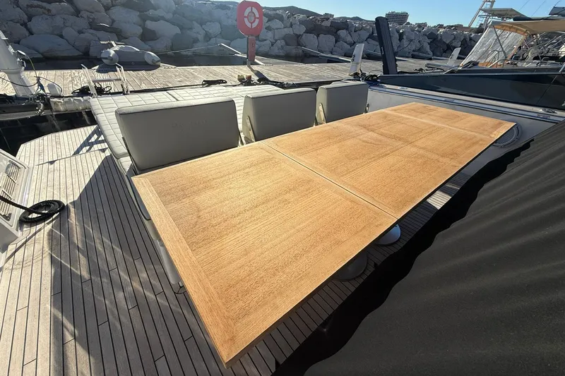 Seoi Yacht Photos Pics 2024 Pardo Yachts P43 deck with wooden table and cushioned seating.