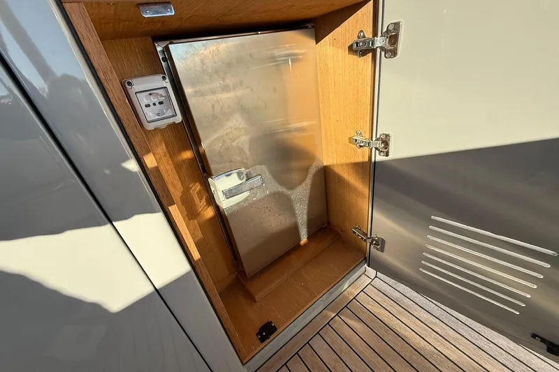 Seoi Yacht Photos Pics Open storage compartment on 2024 Pardo Yachts P43, featuring wooden interior and metal door.