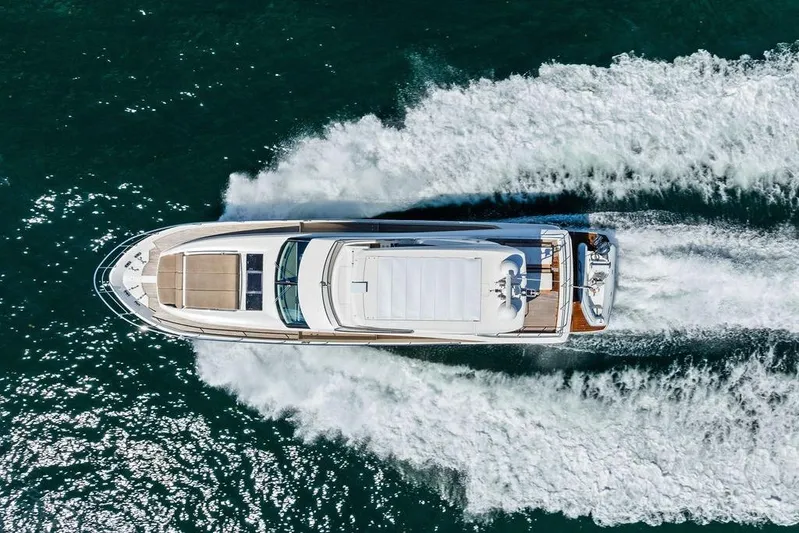 Elevation Yacht Photos Pics Aerial view of 2016 Prestige 750 yacht cruising on open water.