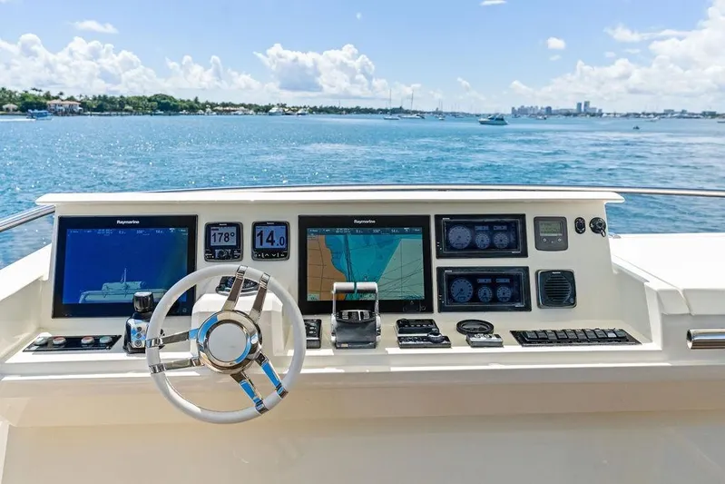 Elevation Yacht Photos Pics Helm of 2016 Prestige 750 yacht with navigation screens, steering wheel, and ocean view.