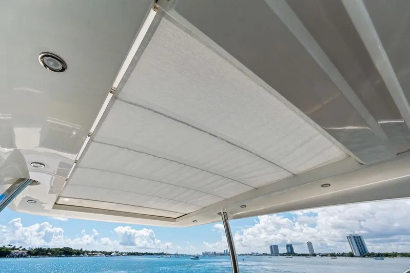 Elevation Yacht Photos Pics View from Prestige 750 yacht's deck, showcasing retractable sunshade and ocean backdrop, 2016 model.