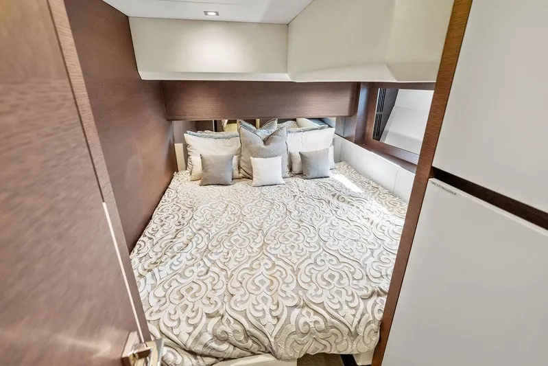 Elevation Yacht Photos Pics Luxurious bedroom interior of 2016 Prestige 750 yacht with elegant bedding and cushions.