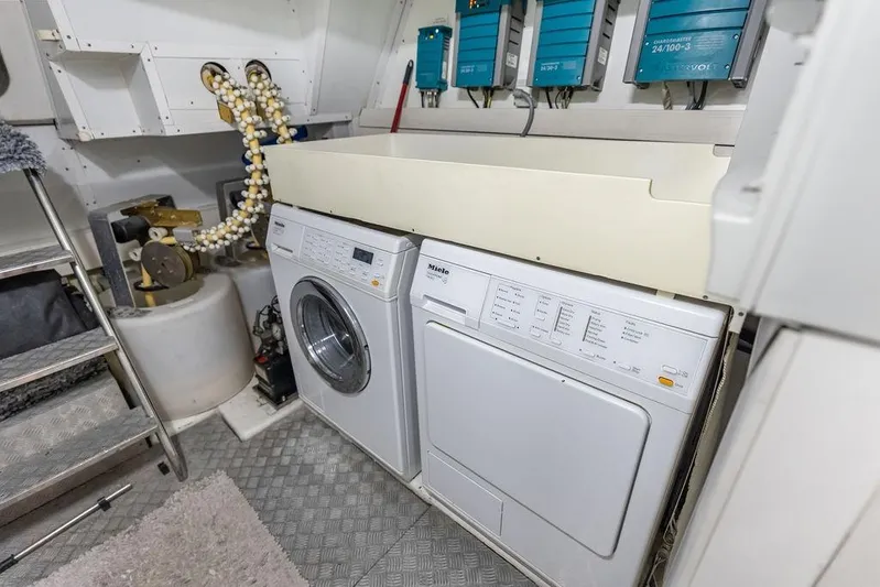 Elevation Yacht Photos Pics Laundry area in a 2016 Prestige 750 yacht with washer and dryer units.