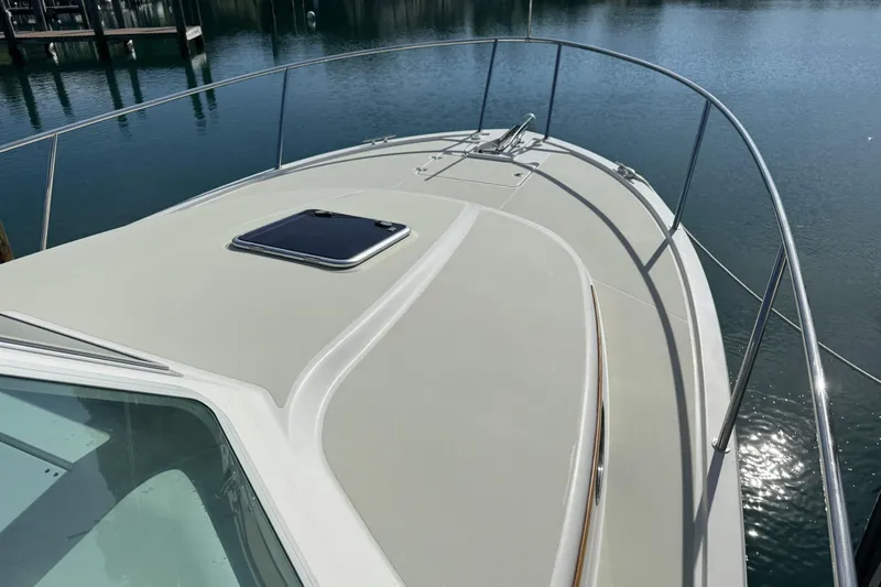 Swell Yacht Photos Pics 2020 Back Cove 34O boat deck with railing, docked on calm water.