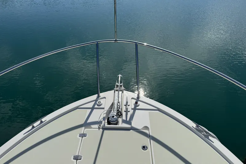 Swell Yacht Photos Pics Bow view of 2020 Back Cove 34O boat on calm water.