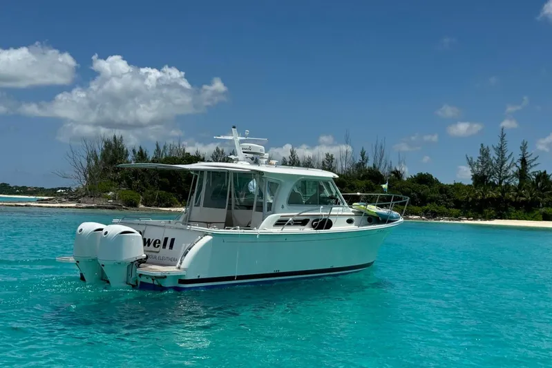 Swell Yacht Photos Pics 2020 Back Cove 34O boat on turquoise water near tropical island.