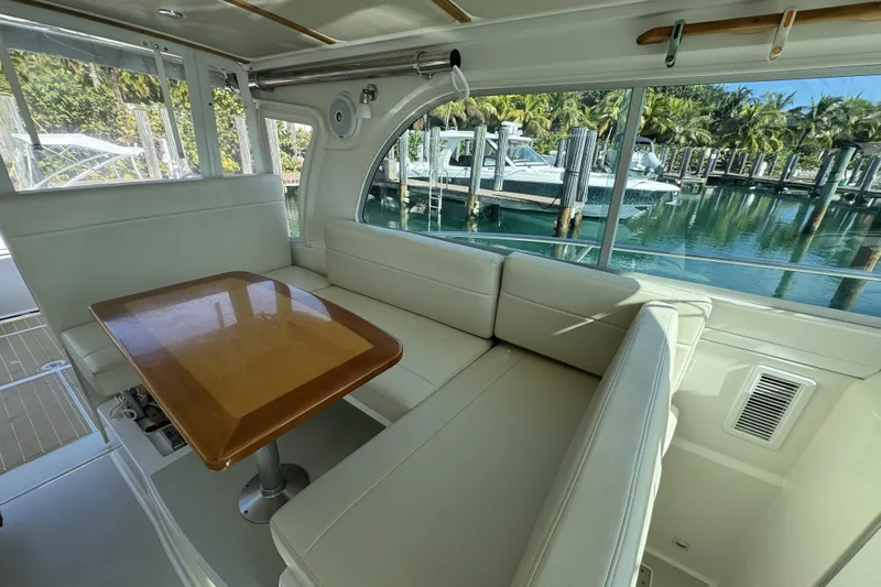 Swell Yacht Photos Pics Interior of 2020 Back Cove 34O yacht with elegant seating and wooden table.