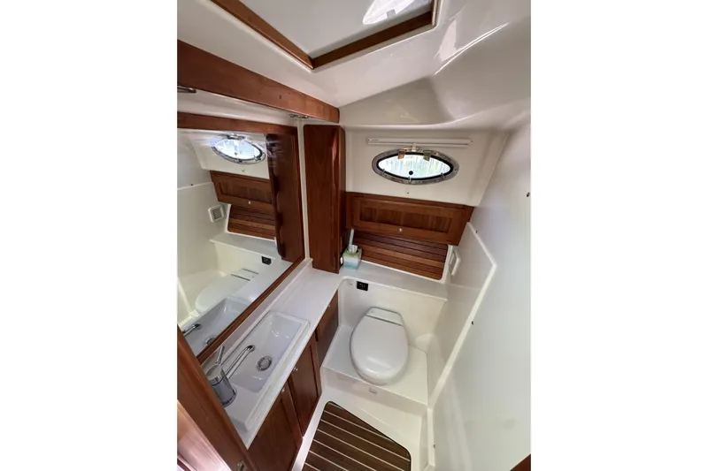 Swell Yacht Photos Pics 2020 Back Cove 34O yacht bathroom with wooden accents and modern fixtures.
