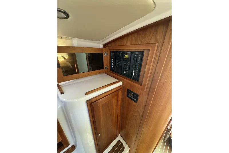 Swell Yacht Photos Pics 2020 Back Cove 34O interior with wooden cabinetry and control panel.