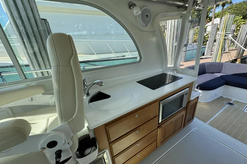 Swell Yacht Photos Pics 2020 Back Cove 34O yacht interior with kitchenette, featuring stove, sink, and microwave.