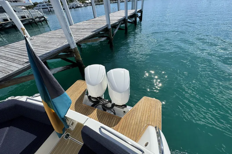 Swell Yacht Photos Pics 2020 Back Cove 34O boat with dual engines docked by clear blue water.