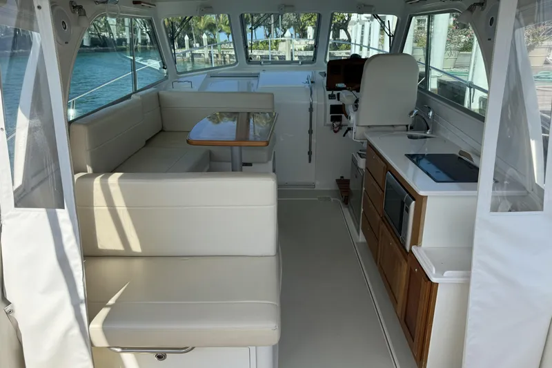 Swell Yacht Photos Pics 2020 Back Cove 34O interior with seating, table, and kitchenette.