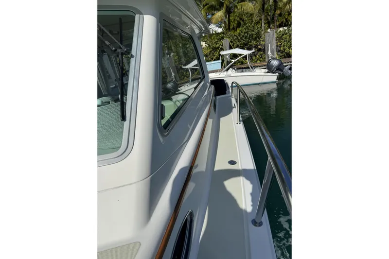 Swell Yacht Photos Pics 2020 Back Cove 34O yacht side view with railing, docked near water.