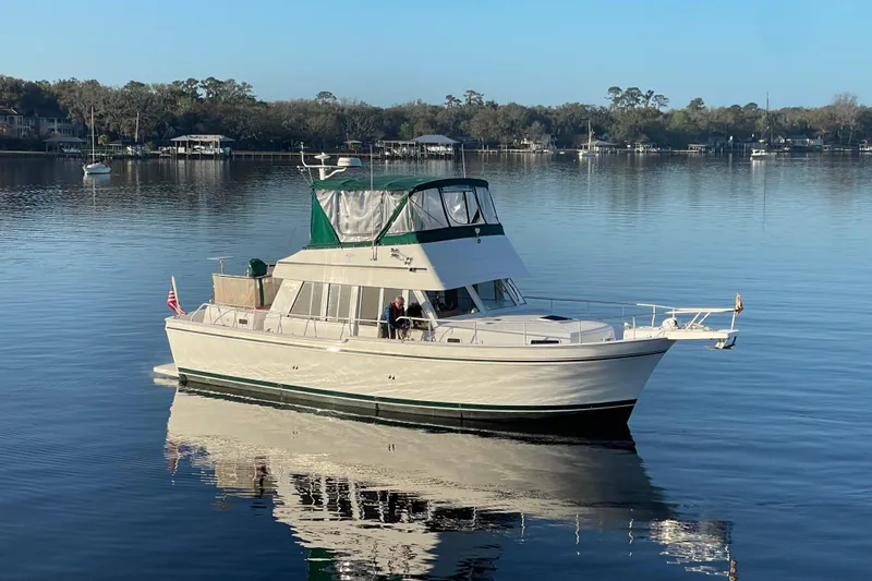 Mary Jean Too Yacht Photos Pics 2003 Mainship 430 Trawler on calm water, scenic background, clear sky.