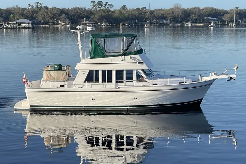 Mary Jean Too Yacht Photos Pics 2003 Mainship 430 Trawler on calm water, featuring green canopy and classic design.