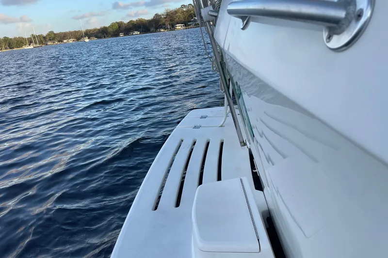 Mary Jean Too Yacht Photos Pics 2003 Mainship 430 Trawler on calm water, showcasing sleek design and sturdy construction.