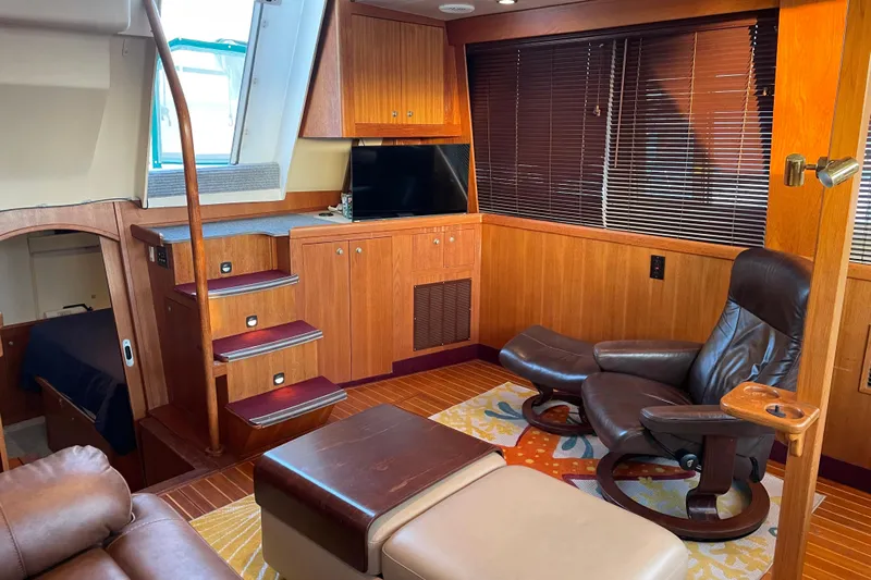 Mary Jean Too Yacht Photos Pics Luxurious interior of 2003 Mainship 430 Trawler with leather seating and wooden cabinetry.