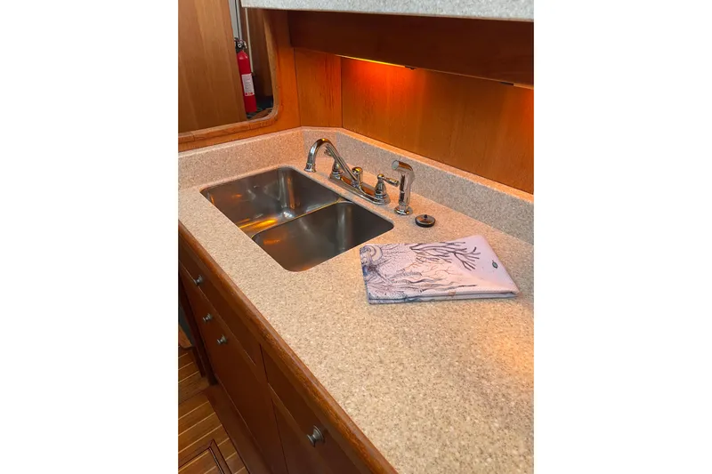 Mary Jean Too Yacht Photos Pics 2003 Mainship 430 Trawler kitchen sink with dual basins and decorative towel.