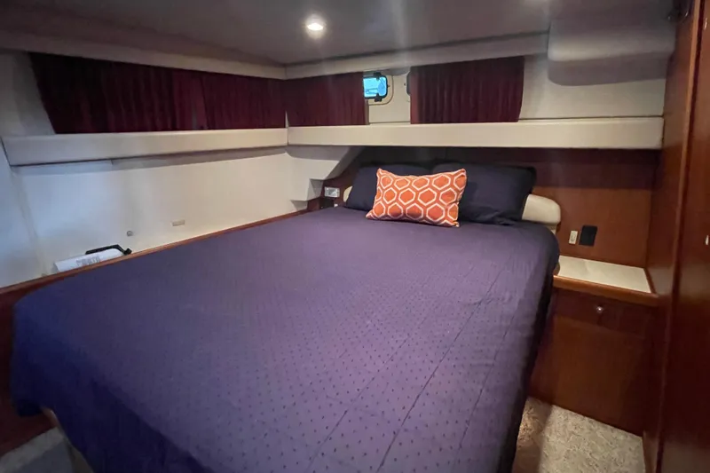 Mary Jean Too Yacht Photos Pics Cozy bedroom in 2003 Mainship 430 Trawler with purple bedding and decorative pillow.