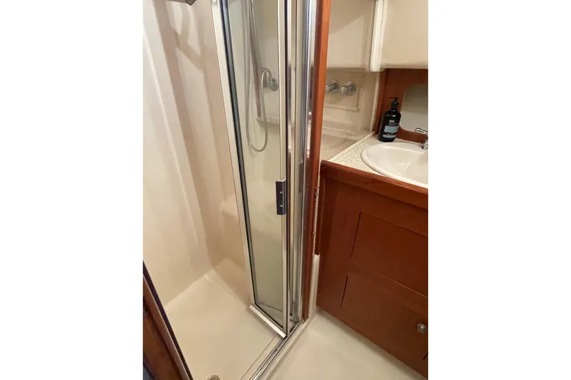 Mary Jean Too Yacht Photos Pics 2003 Mainship 430 Trawler bathroom with shower and sink area.