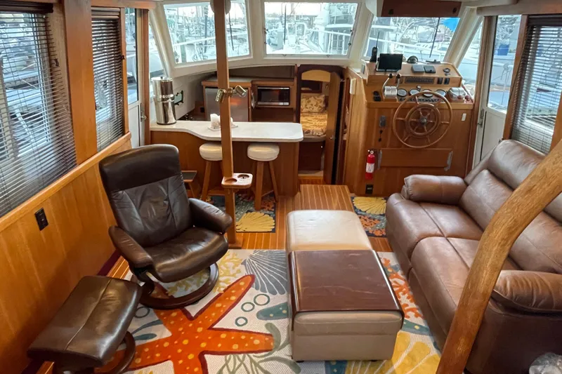 Mary Jean Too Yacht Photos Pics Interior of 2003 Mainship 430 Trawler with leather seating and nautical decor.