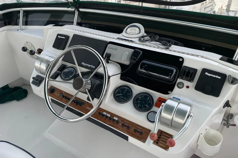 Mary Jean Too Yacht Photos Pics 2003 Mainship 430 Trawler helm with Raymarine electronics and steering wheel.
