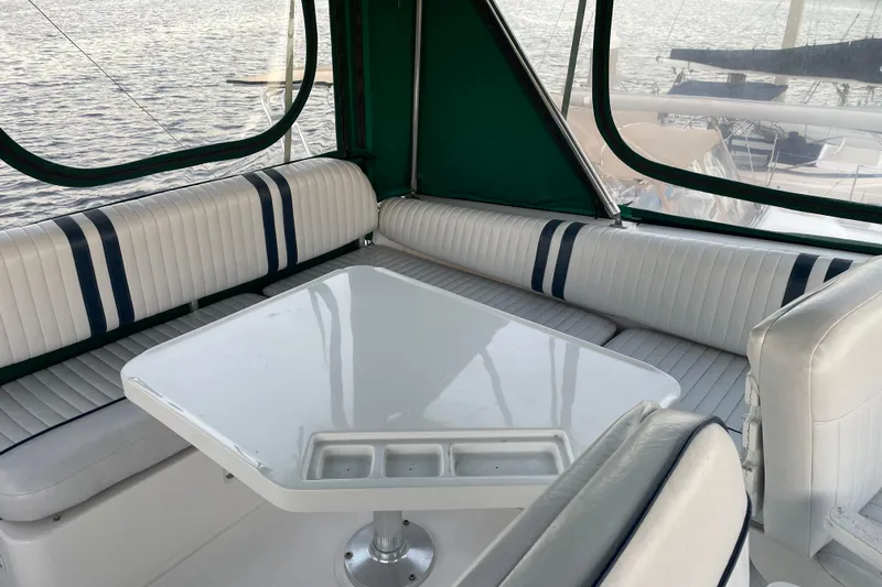 Mary Jean Too Yacht Photos Pics 2003 Mainship 430 Trawler interior with white seating and table, overlooking water.