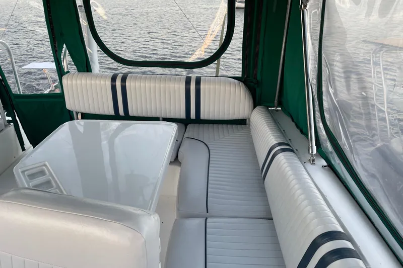 Mary Jean Too Yacht Photos Pics 2003 Mainship 430 Trawler interior with white seating and table, overlooking water.