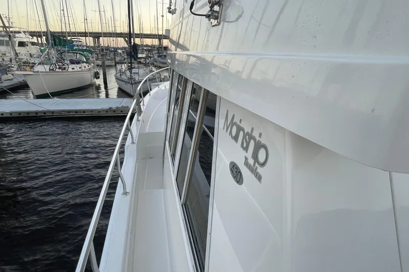 Mary Jean Too Yacht Photos Pics 2003 Mainship 430 Trawler docked at marina with sailboats in background.