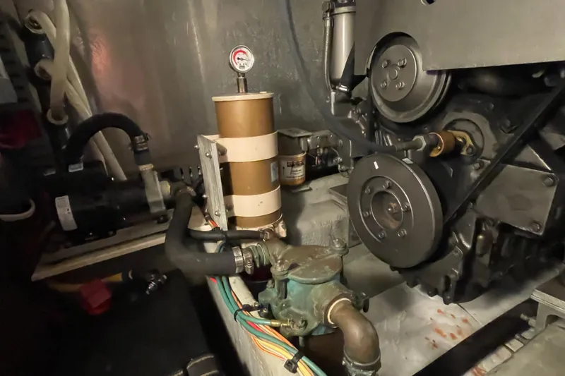 Mary Jean Too Yacht Photos Pics Engine room of 2003 Mainship 430 Trawler, showcasing mechanical components and piping.